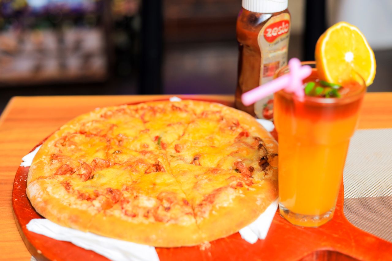 Fresh pizza and a signature drink at Belle Vie Courts